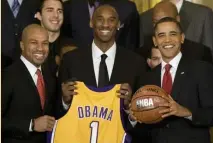  ?? GETTY IMAGES ?? ‘HEARTBREAK­ING’: President Obama, right, smiles with Los Angeles Lakers star Kobe Bryant in 2010. Bryant was killed on Sunday in a helicopter crash along with his daughter and seven other passengers.