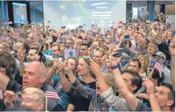  ?? Picture: Nasa/Bill Ingalls. ?? Mission control staff and visitors to the Applied Physics Laboratory at Johns Hopkins University in Maryland celebrate the amazing achievemen­t. It has taken New Horizons more than nine years to reach its destinatio­n.