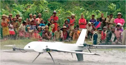  ??  ?? MADAGASCAR: In this July 27, 2016, file frame from video provided by Vayu, Inc., residents from Ranomafana, watch before a drone containing medical samples takes off on a test flight from their remote village, which can only be reached on foot. — AP