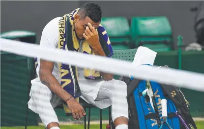  ??  ?? UNLUCKY: Australia’s Nick Kyrgios receives treatment before retiring from his first round match at Wimbledon.