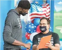  ?? JOE BURBANK/ ORLANDO SENTINEL ?? Orlando Magic center Mohamed Bamba listens to Orange County Supervisor of Elections Bill Cowles during the National Voter Registrati­on Day event, hosted by the Orlando Magic at Amway Center in September 2020.