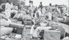  ?? GETTY IMAGES ?? People waiting by the Brahmaputr­a for the steamers. It was chaos at the
ghat, with children crying, people forgetting to carry money and precious belongings...