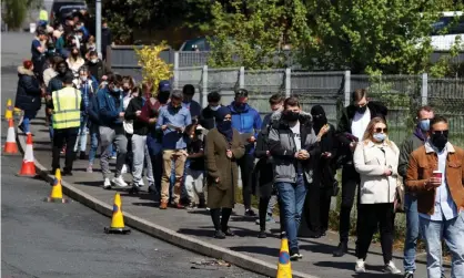  ??  ?? People queue outside a mobile vaccine centre in Bolton on 16 May. Photograph: Phil Noble/Reuters