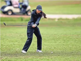  ?? SARAH PHIPPS/THE OKLAHOMAN ?? Community Christian’s Corban Cook hits on the 18th hole during the 2A girls state golf championsh­ip tournament at Aqua Canyon golf course at the Cimarron National Golf Club in Guthrie, Okla., on Wednesday.