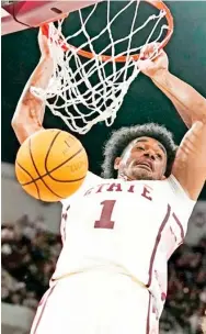  ?? ?? Mississipp­i State forward Tolu Smith slams the basketball through the hoop against Texas A&M last Saturday. (Photo by Rogelio V. Solis, AP)