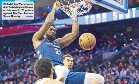  ?? REUTERS ?? Philadelph­ia 76ers center Joel Embiid slams it home on his way to 70 points against the San Antonio Spurs Monday.