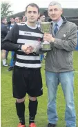  ??  ?? Presentati­on Glencairn captain Ross Ballantyne receives the cup from Cambuslang Rangers chairman Billy Miller
