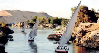  ??  ?? Feluccas (Egyptian Nile sailboats) maneuver between islands in the Nile River off the Egyptian city of Aswan in this file photo taken in April 2005. Today the Greek community in Egypt numbers about 5,000 people.