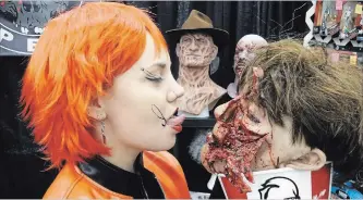  ?? JOHN LAW
THE NIAGARA FALLS REVIEW ?? Esther McCleery of Toronto makeup FX shop Blood Opera has a finger-lickin' good time at this weekend's Frightmare in the Falls. The two-day event at Scotiabank Convention Centre gathered fans and horror icons.