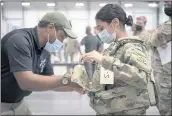  ?? JASON AMADI — U.S. ARMY VIA AP ?? U.S. Army Sgt. Katiushka Rivera gets fitted for a modular scalable vest during a fielding event in Fort Bragg, N.C., on Sept. 13.