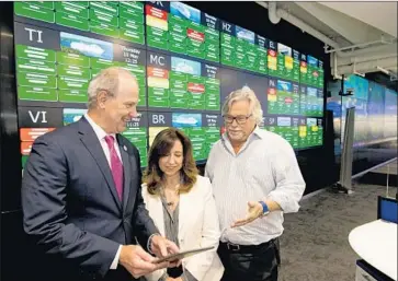  ?? Andy Newman TNS ?? CHRISTINE DUFFY, center, president of Carnival Cruise Line, with Chief Maritime Officer William Burke, left, and Carnival Corp. Chairman Micky Arison. Duffy runs the world’s largest cruise company with 26 ships.