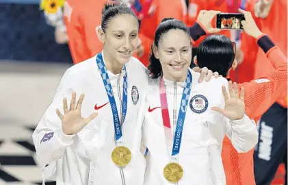  ?? CHARLIE NEIBERGALL/AP ?? Team USA’S Diana Taurasi, left, and Sue Bird, both former Uconn stars, make it five Olympic gold medals each after beating Japan 90-75 on Sunday in Saitama, Japan.