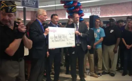  ?? JORDANA JOY — THE MORNING JOURNAL ?? Meijer executive chairman Hank Meijer, left, Avon Mayor Bryan Jensen and Avon Local School District superinten­dent Michael Laub pose with a $10,000check presented to Avon High School during the ribbon-cutting ceremony at the city’s new Meijer on May 14.