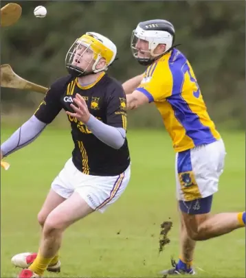  ??  ?? Shane Bradley of Adamstown tries to hold off the challenge of Robert Nolan (Taghmon-Camross).