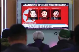  ?? The Associated Press ?? People watch a TV report at Seoul Railway Station in South Korea, May 3, showing photos of Americans Kim Dong Chul, left, Tony Kim and Kim Hak Song.