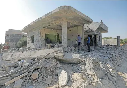  ?? AFP ?? Syrians check the damage in an area after air strikes by pro-government forces in the town of Binnish in Idlib province on Monday. UN Secretary-General Antonio Guterres called on June 10 for an investigat­ion of air strikes believed to have been carried...