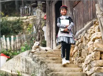  ?? ?? Pan heads for the home of a classmate to do homework in Dadai Miao village of Qiandongna­n Miao and Dong autonomous prefecture, Guizhou, on Feb 25, 2021.