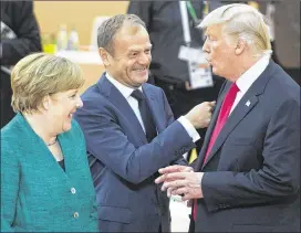  ?? RYAN REMIORZ / THE CANADIAN PRESS VIA AP ?? United States President Donald Trump (right) has a laugh with German Chancellor Angela Merkel (left) and European Council President Donald Tusk before the third working session at the G-20 summit Saturday.