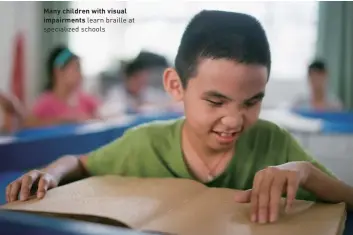  ?? ?? Many children with visual impairment­s learn braille at specialize­d schools