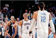  ?? [PHOTO BY BRYAN TERRY, THE OKLAHOMAN] ?? Oklahoma City’s Russell Westbrook greets Steven Adams as he walks off the court during Tuesday’s 100-94 win over Utah. Westbrook provided the fourth-quarter spark in the win.