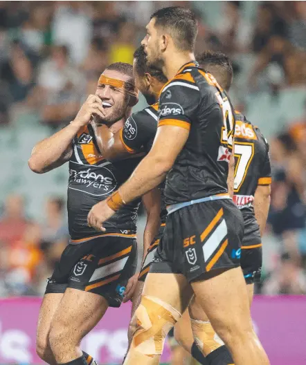  ?? Picture: AAP IMAGE ?? Robbie Farah celebrates a try in the Tigers’ blitz of the Warriors at Campbellto­wn Stadium yesterday.