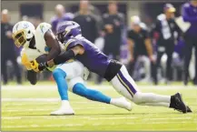  ?? AP photo ?? Chargers wide receiver Mike Williams is tackled by Vikings cornerback Byron Murphy Jr. during Los Angeles’ win over Minnesota on Sunday.