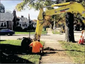  ?? KARA DRISCOLL / STAFF ?? Workers dig up and replace a water main line on Cushing Avenue off Shroyer Road in Kettering. A new state law requires stronger water-quality reporting.