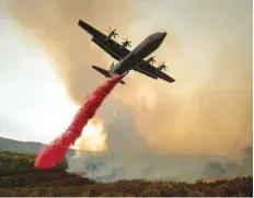  ?? — AFP ?? An air tanker drops retardant on the Ranch Fire burning along High Valley Rd near Clearlake Oaks, California.