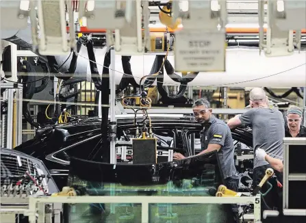  ?? THE CANADIAN PRESS FILE PHOTO ?? Line workers assemble a Lexus sport utility vehicle at Toyota’s plant in Cambridge.