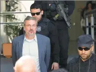  ?? PAULO LISBOA / REUTERS ?? Brazil's former finance minister Antonio Palocci is escorted by police in Curitiba, Brazil, on Monday.