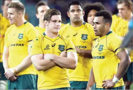  ?? AFP ?? Australia captain Michael Hooper (front left) and teammate Will Genia (front right) react after their loss to Scotland in their Test match in Sydney on June 17.