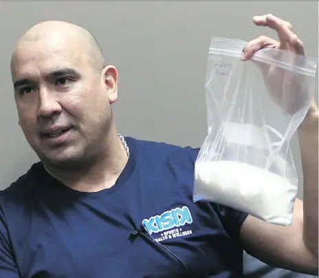  ?? JEFF LOSIE ?? Carlin Nordstrom holds up a bag of sugar which is the equivalent sugar found in two small bottles of pop per day over one week. Nordstrom, who gives motivation­al talks in Indigenous schools and wants First Nations to ban pop from their schools.