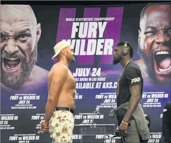  ?? PHOTO BY GENE BLEVINS ?? Deontay Wilder, right, has a silent stare off with Tyson Fury on Tuesday ahead of their July 24fight in Las Vegas.