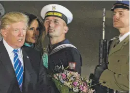  ??  ?? President Donald Trump and first lady Melania Trump walk past the Polish Army honor guards upon their arrival in Warsaw on Wednesday.
| ALIK KEPLICZ/ AP