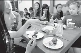  ?? Christina House For The Times ?? A MEATBALL TASTING for about two dozen students at Janson Elementary School in Rosemead is conducted by Panda Express executives in March.