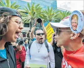  ?? Irfan Khan Los Angeles Times ?? DONALD TRUMP supporter Jake Towe, right, faces off with anti-Trump protester Joshua Gonzalez, left, outside the Anaheim Convention Center in May.