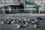  ?? JOHN MINCHILLO — AP ?? Shoes are piled outside the scene of a mass shooting including Ned Peppers bar, Sunday, Aug. 4, in Dayton.