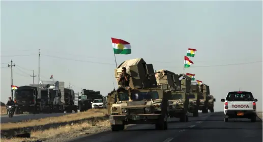  ??  ?? KURDISH PESHMERGA vehicles rush to the front line at Altun Kupri after clashes with Iraqi security forces last Friday.