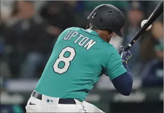  ?? TED S. WARREN – THE ASSOCIATED PRESS ?? Seattle Mariners' Justin Upton is hit by a pitch during the fifth inning by Angels Michael Lorenzen on Friday in Seattle. Lorenzen blamed the condition of the ball for the incident. Upton left the game after the injury.