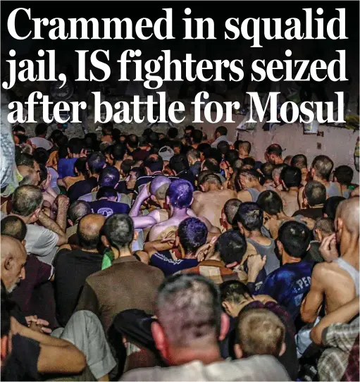  ??  ?? Captured: Sitting in soaring temperatur­es many of these Islamic State suspects have been held for months