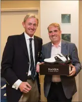  ??  ?? Ciaran Lally, a winner in the President’s Prize competitio­n at Blainroe Golf Club, receives their prize from Club President Terence Ryan.