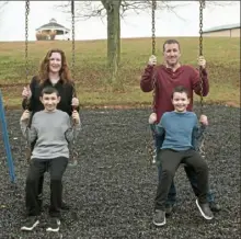  ?? Pittsburgh Post-Gazette ?? Daniel Price and his wife, Stacey, with their sons Samuel, 10, left, and Noah, 7, in the South Franklin Park.