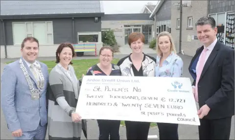  ??  ?? Clllr. Liam Reilly, Chairman, Louth County Council, with members of the Parents’ Council, Laureen O’Connor, Imelda Whyte, Emma McQuillan and Michelle Farrelly making a €12,727 cheque presentati­on to Principal, Pat Mulligan at the official opening the second extension at St. Peter’s National School, Dromiskin. The money was raised when the Parents’ Council held a Black Tie Gala fundraiser in Bellingham Castle.