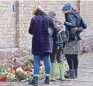  ??  ?? People mourn outside the synagogue in Halle, Germany yesterday, a day after a shooting incident killed two persons.