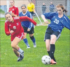  ?? CHRISTIAN ROACH/CAPE BRETON POST ?? Reece Brown of Sydney Academy makes a move as Lindsey Ripley of Riverview tries to catch her during the high school’s teams season opener at Riverview on Tuesday. Riverview blanked SA 10–0 in the contest.