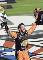  ?? JASEN VINLOVE/USA TODAY SPORTS ?? Martin Truex Jr. celebrates Sunday night after winning the Coca-Cola 600 at Charlotte Motor Speedway.