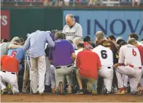  ?? JONATHAN NEWTON/THE WASHINGTON POST ?? The House chaplain leads Democrats and Republican­s in prayer at second base before the congressio­nal baseball game Thursday at Nationals Park in Washington, D.C. The Democrats won the game 11-2.