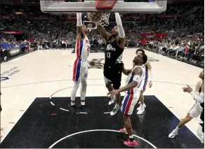  ?? RAUL ROMERO JR. — THE ASSOCIATED PRESS ?? Clippers forward Paul George (13) dunks the ball past Pistons guard Jaden Ivey in the second half en route to scoring 33 points in a 112-106 victory Saturday at Crypto.com Arena.