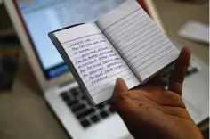  ?? (AP Photo/RS Iyer) ?? Indian journalist Sidhique Kappan at his home in Kerala, India, shows notes from the diary he kept in prison, on April 1. He was charged in 2020 on allegation­s of inciting violence while trying to report on a government clampdown in the northern Uttar Pradesh state ruled by the party of Prime Minister Narendra Modi.