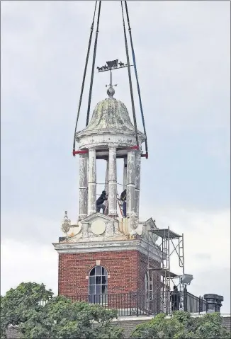  ?? [ERIC ALBRECHT/DISPATCH] ?? The project to replace this rotted wooden cupola atop West High School didn’t involve the Columbus school district’s usual process of competitiv­e, sealed bids. The district now favors using a scoring system, an option allowed under a 2011 state law.